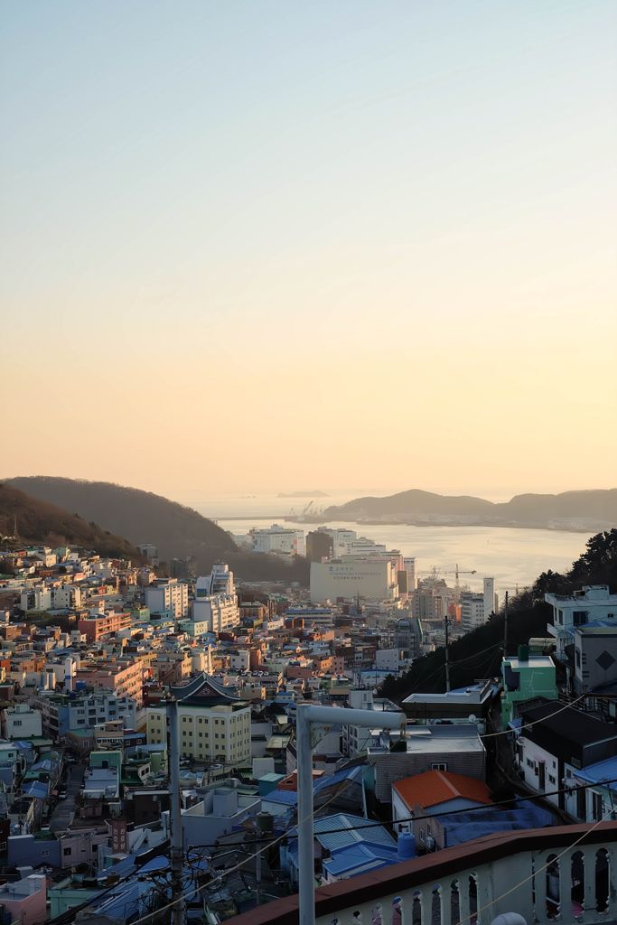 A breathtaking view of the sunset illuminating the vibrant cityscape of Busan, South Korea.