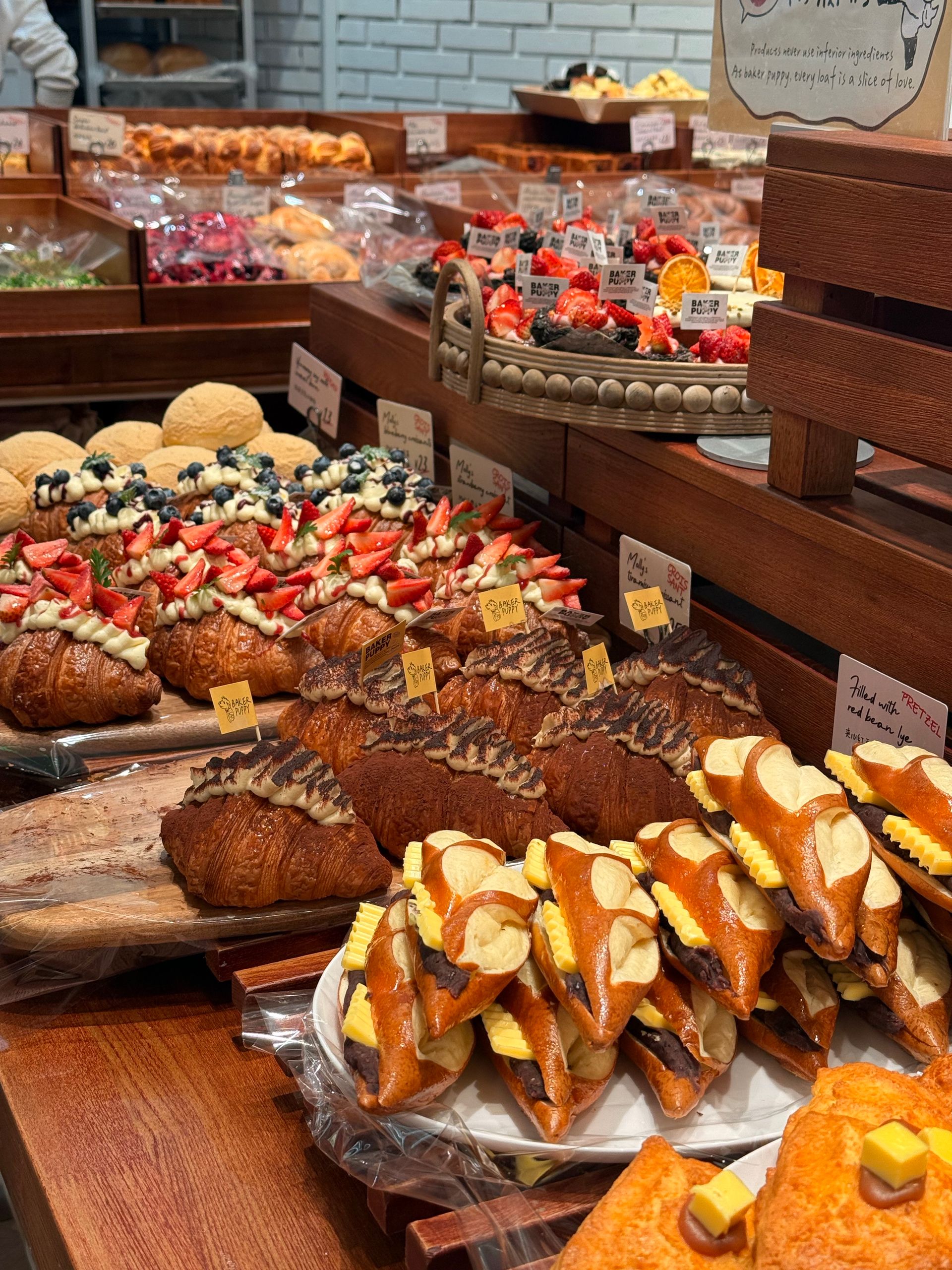 Explore a tempting selection of fresh pastries at a bakery display, ready to delight any visitor.